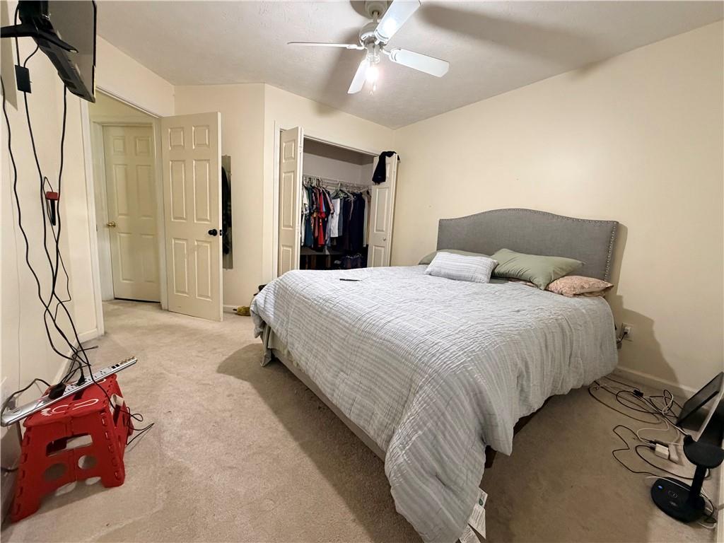426 Pates Lake Court Hampton, GA 30228 - Photo 21 of 60 a bedroom with a bed and a chandelier