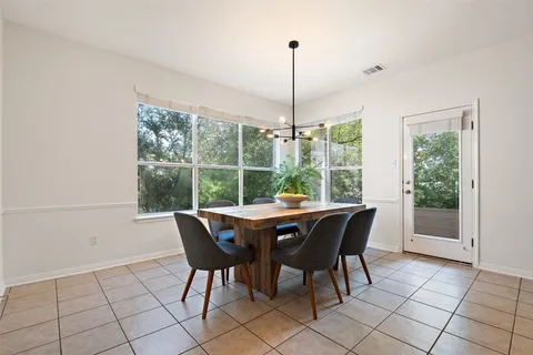 a dining room that has a table and a chair