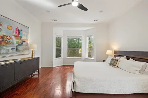 a large white bed in a room next to a window