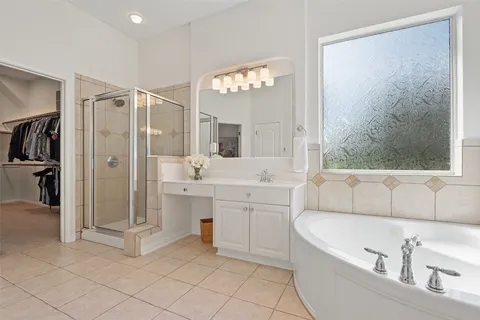 a bathroom with a tub a sink and mirrors