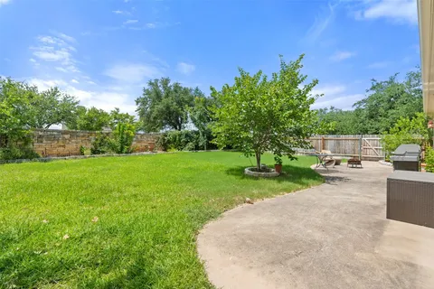 a view of a house with backyard and a slide