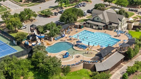 a view of a city with lush green forest