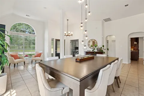 a view of kitchen island with stainless steel appliances furniture stove and living room view