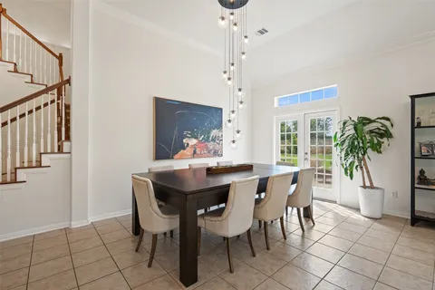 a view of a dining room with furniture and chandelier