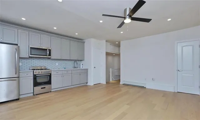 a kitchen with kitchen island granite countertop cabinets and refrigerator