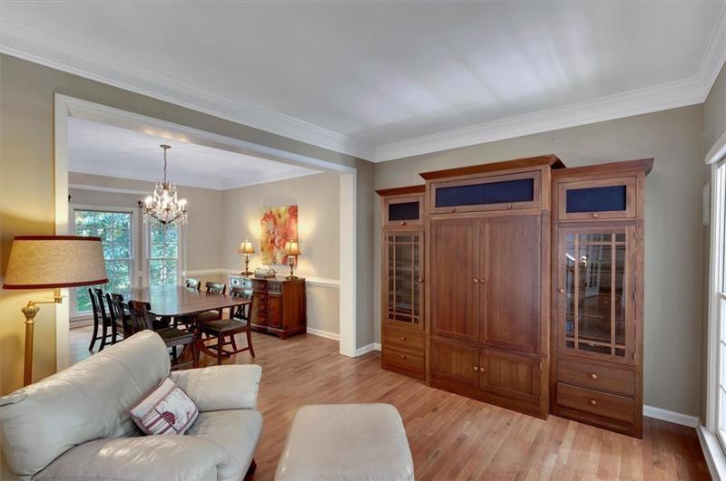 1170 Spring Oak Way Cumming, GA 30041 - Photo 13 of 77 a living room with furniture and a chandelier