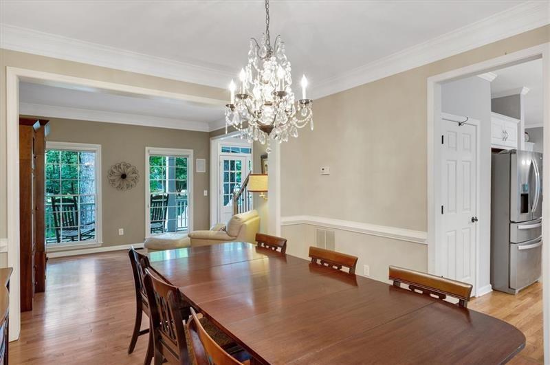 1170 Spring Oak Way Cumming, GA 30041 - Photo 16 of 77 a room with chandelier furniture and windows