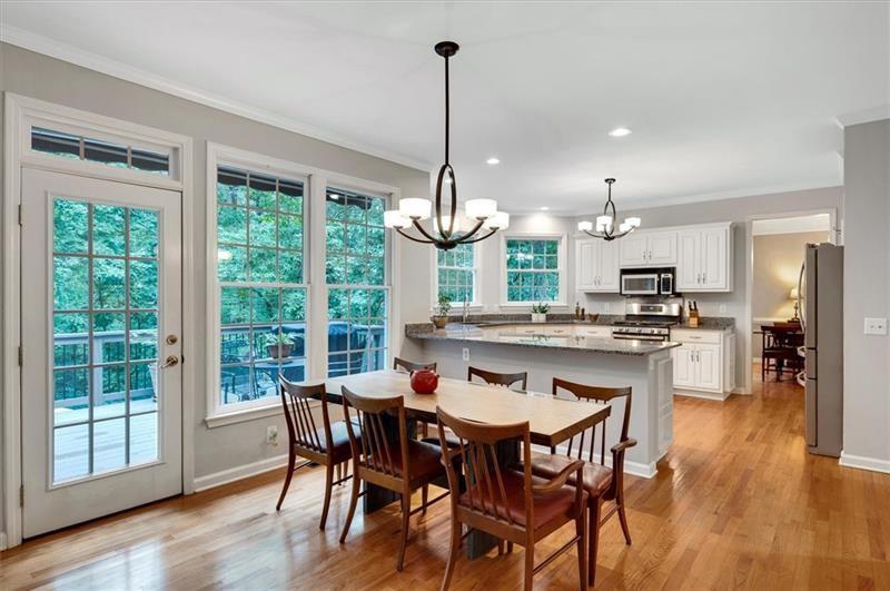 1170 Spring Oak Way Cumming, GA 30041 - Photo 17 of 77 a view of a dining room and livingroom with furniture wooden floor a chandelier