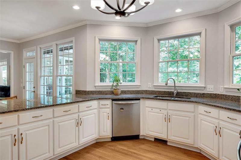 1170 Spring Oak Way Cumming, GA 30041 - Photo 19 of 77 a kitchen with granite countertop white cabinets and a large window