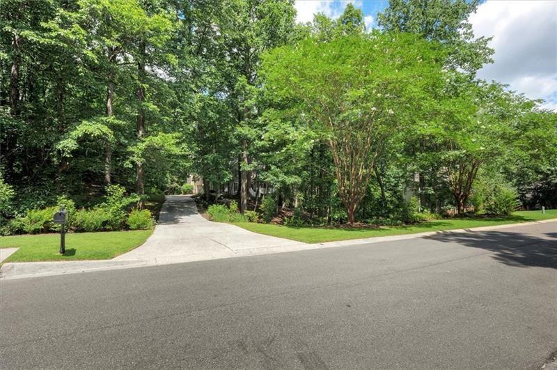 1170 Spring Oak Way Cumming, GA 30041 - Photo 2 of 77 a view of a road with a yard