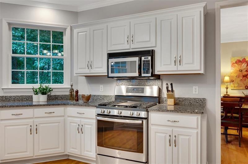 1170 Spring Oak Way Cumming, GA 30041 - Photo 21 of 77 a kitchen with granite countertop white cabinets stainless steel appliances and a window
