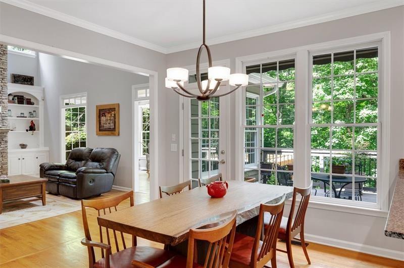 1170 Spring Oak Way Cumming, GA 30041 - Photo 25 of 77 a view of a dining room with furniture large windows and wooden floor