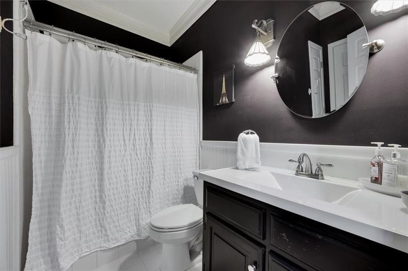 1170 Spring Oak Way Cumming, GA 30041 - Photo 31 of 77 a bathroom with a sink a toilet and mirror