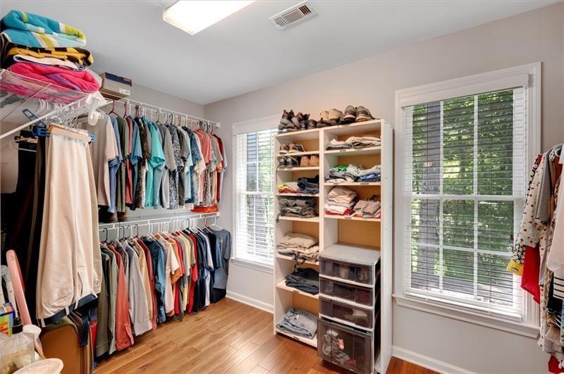 1170 Spring Oak Way Cumming, GA 30041 - Photo 39 of 77 a view of walk in closet with clothes and shoes