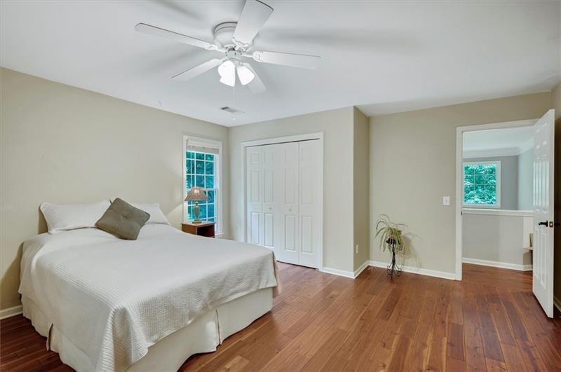 1170 Spring Oak Way Cumming, GA 30041 - Photo 40 of 77 a bedroom with a large bed and a chandelier