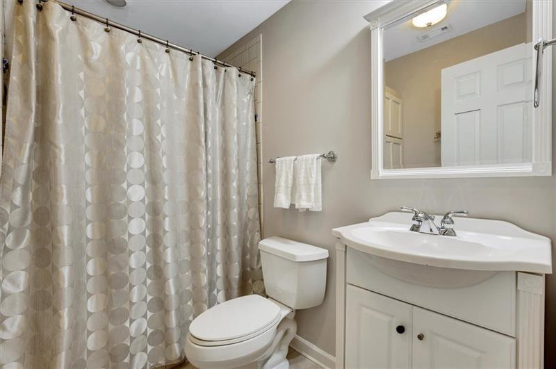 1170 Spring Oak Way Cumming, GA 30041 - Photo 54 of 77 a bathroom with a sink a toilet and shower curtain
