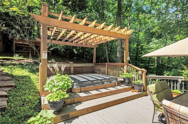 1170 Spring Oak Way Cumming, GA 30041 - Photo 60 of 77 a view of a patio with table and chairs potted plants with wooden floor and fence