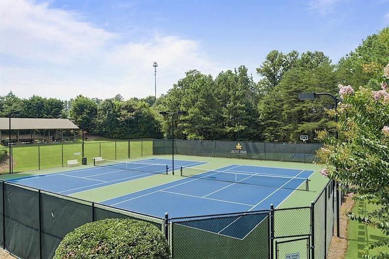 1170 Spring Oak Way Cumming, GA 30041 - Photo 73 of 77 a view of a tennis ground with large trees
