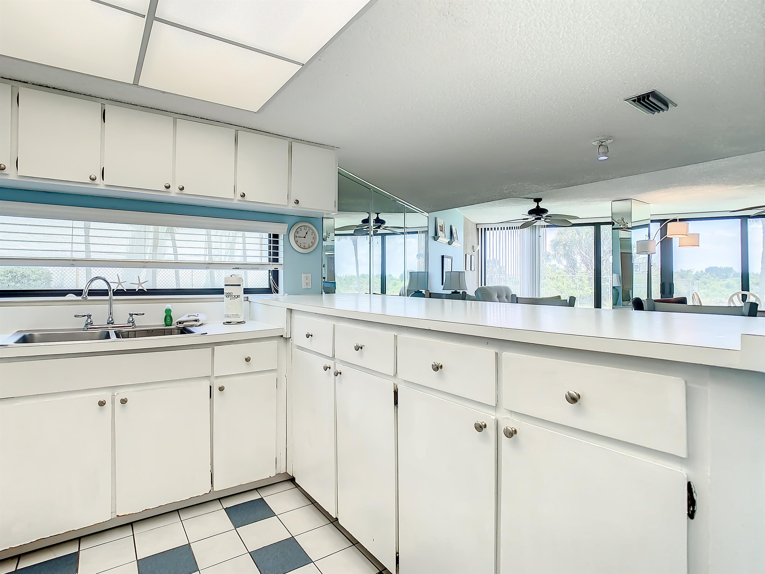 2 Dondanville Road, Unit 110 St. Augustine, FL 32080 - Photo 11 of 38 a kitchen with white cabinets sink and white appliances