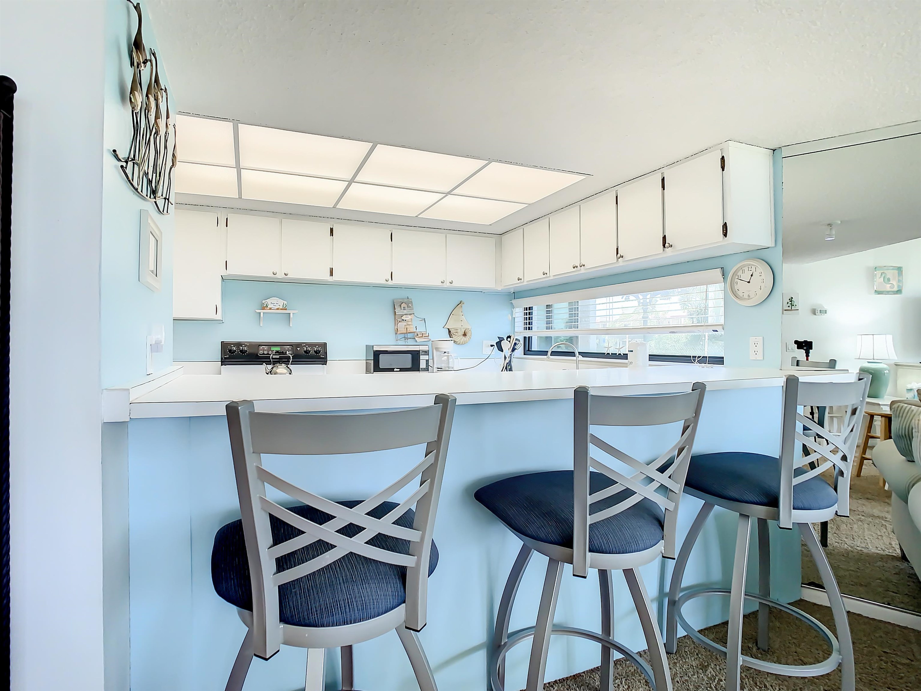 2 Dondanville Road, Unit 110 St. Augustine, FL 32080 - Photo 12 of 38 a kitchen with stainless steel appliances a dining table chairs and a refrigerator