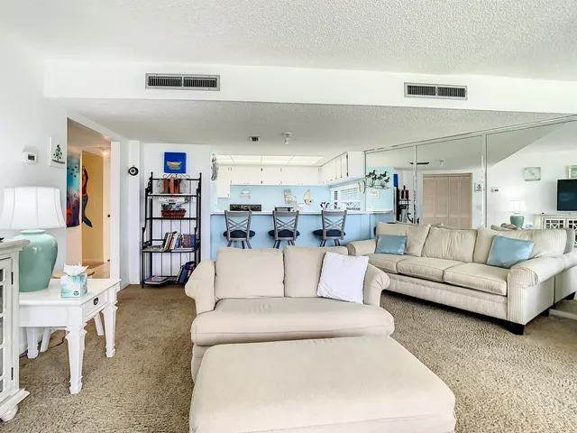 a living room with furniture and a book shelf