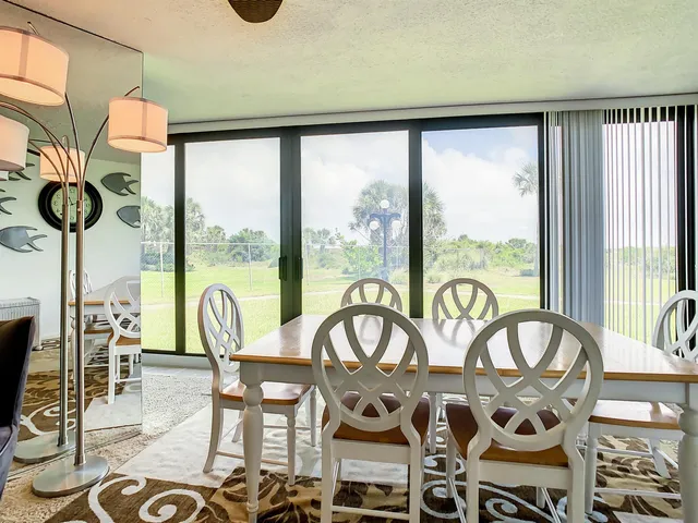 a view of a patio with table and chairs