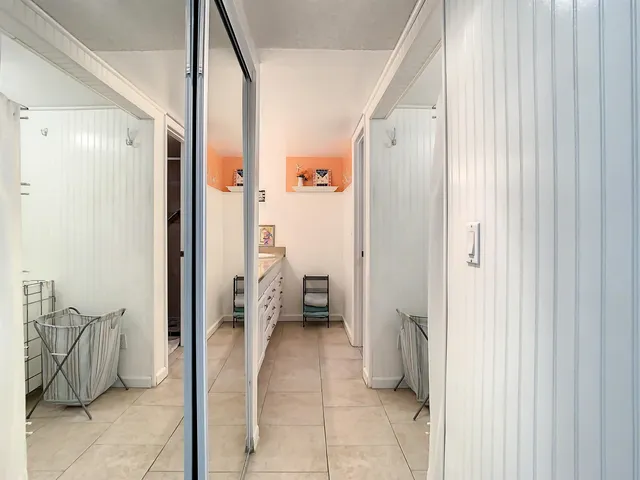 a bathroom with a tub and a view of bathroom