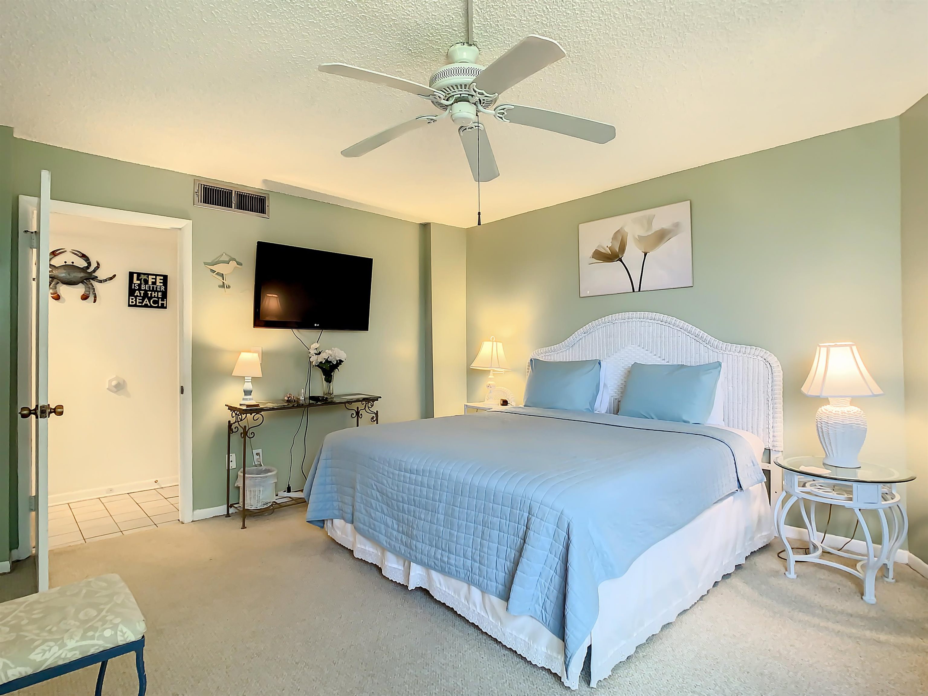 2 Dondanville Road, Unit 110 St. Augustine, FL 32080 - Photo 26 of 38 a bedroom with a bed and a flat screen tv
