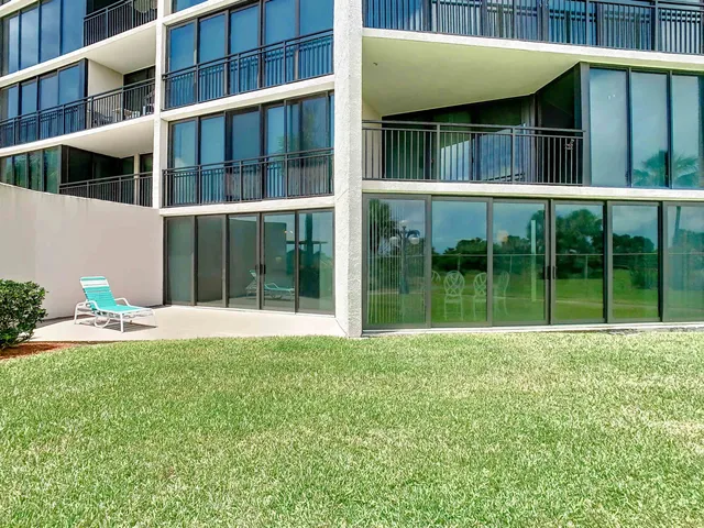 a view of an house with backyard space and balcony