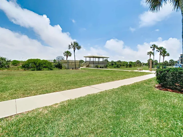 a view of a park and trees in the background