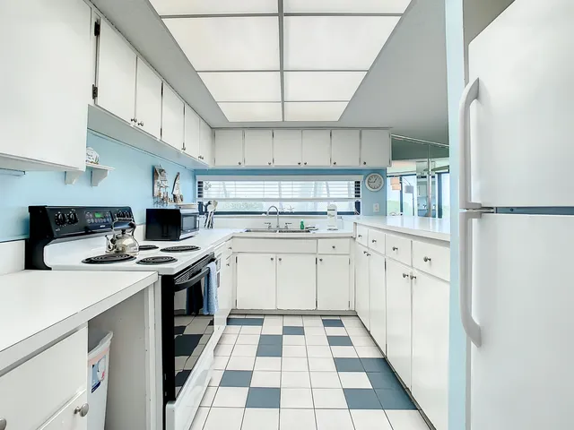 a kitchen with a stove a sink and a refrigerator
