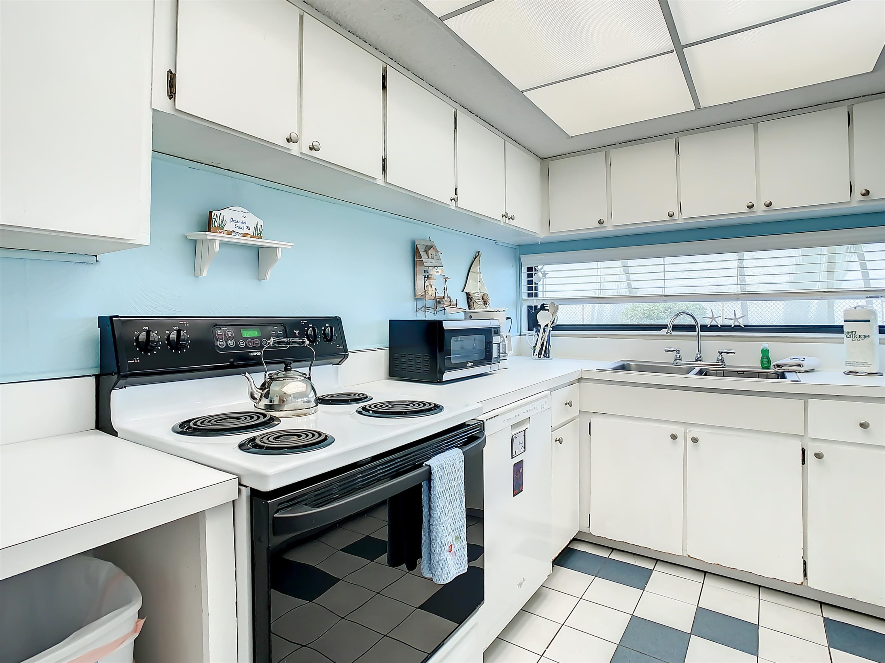 2 Dondanville Road, Unit 110 St. Augustine, FL 32080 - Photo 10 of 38 a kitchen with stainless steel appliances granite countertop a sink stove and cabinets