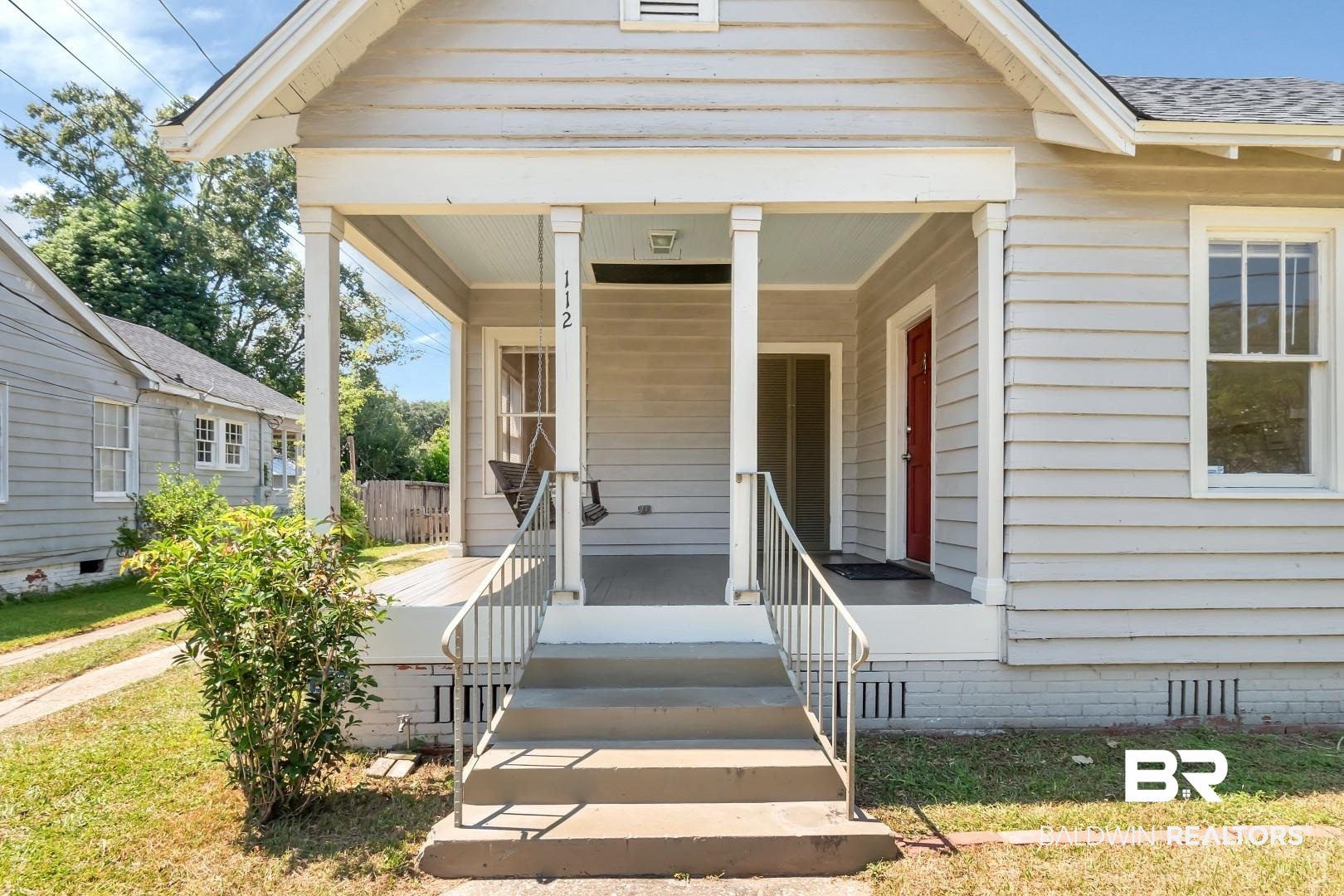 112 South Fulton Street Mobile, AL 36606 - Photo 3 of 35 View of exterior entry featuring a lawn and a porch