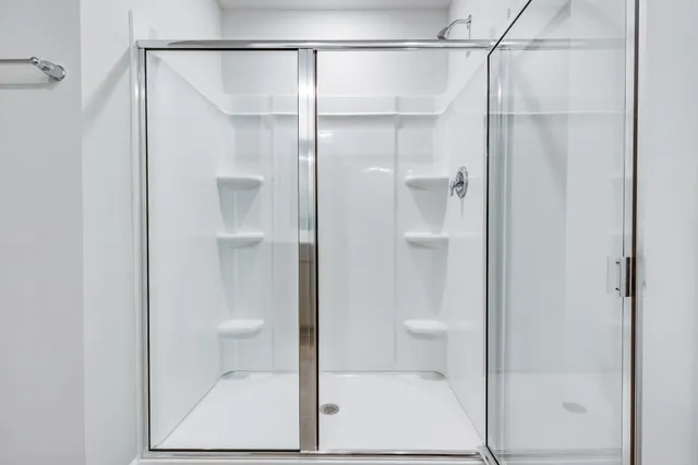 a bathroom with a glass shower door
