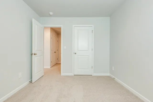 an empty room with closet area