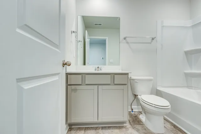 a bathroom with a toilet a sink and a mirror