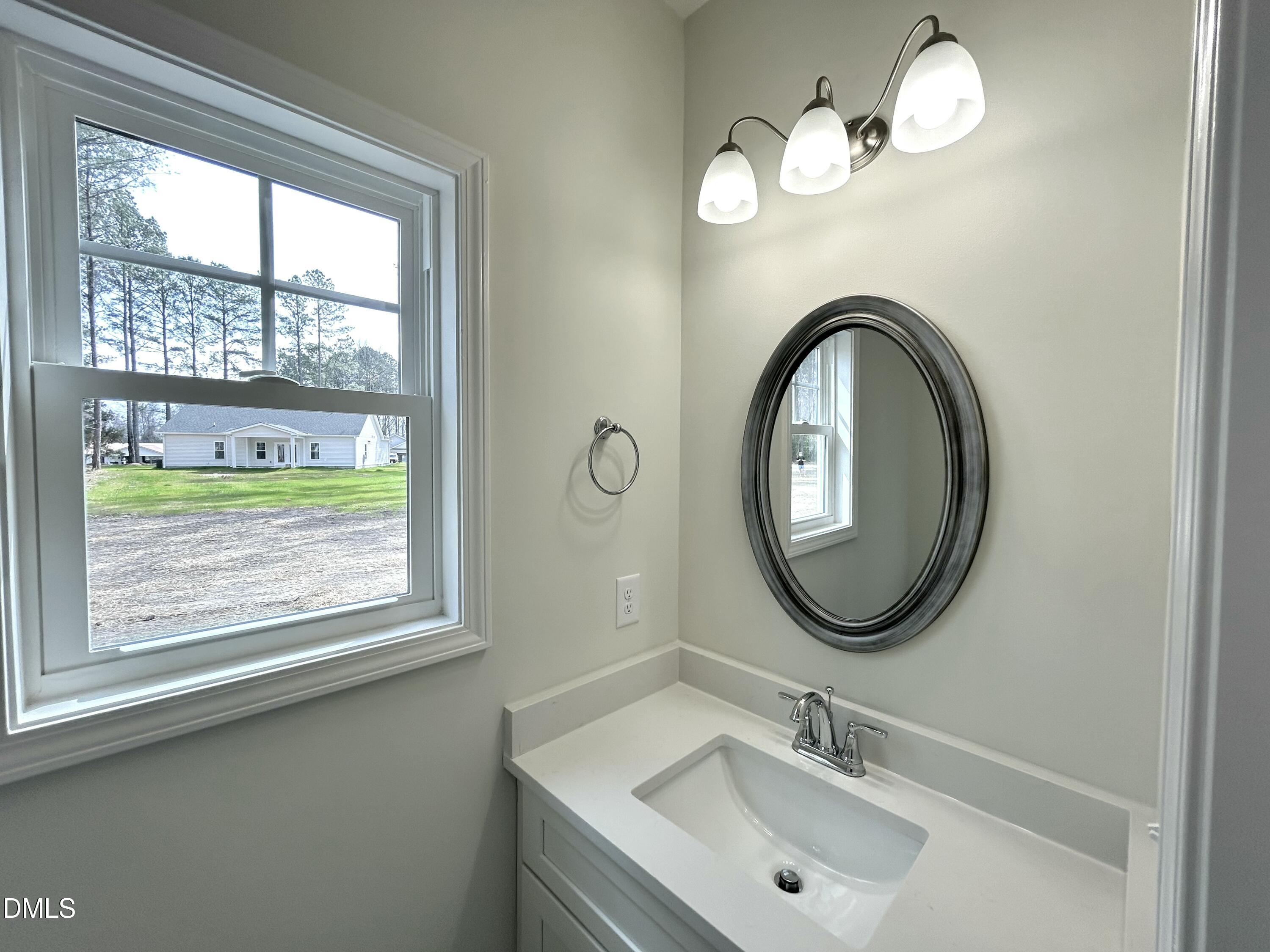 1739 Cardinal Drive Deep Run, NC 28525 - Photo 11 of 29 a bathroom with a sink and a mirror