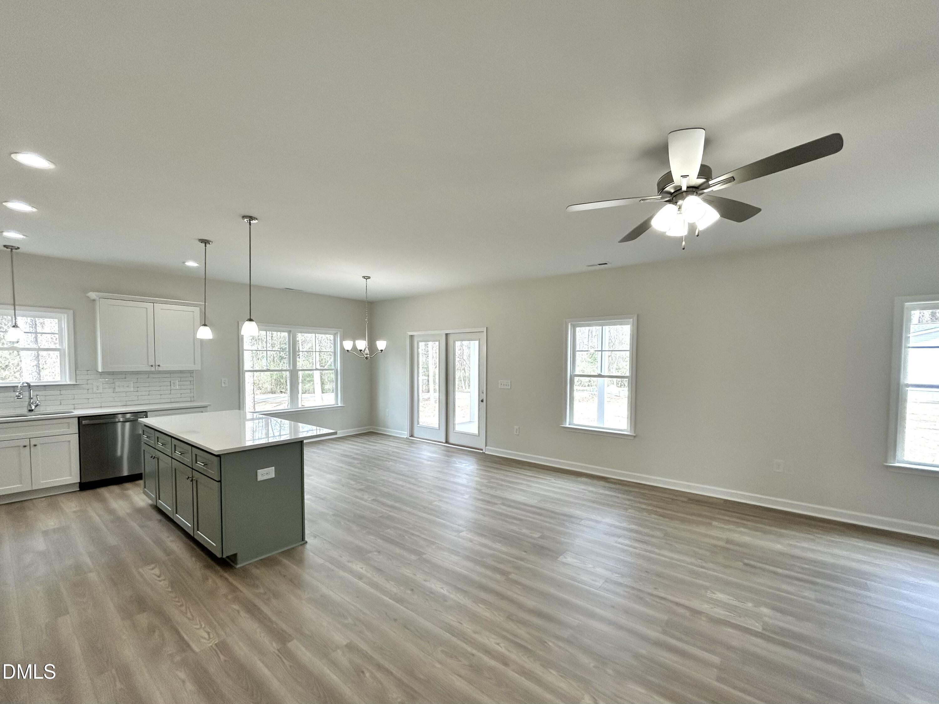 1739 Cardinal Drive Deep Run, NC 28525 - Photo 14 of 29 a living room with couches and kitchen view with wooden floor