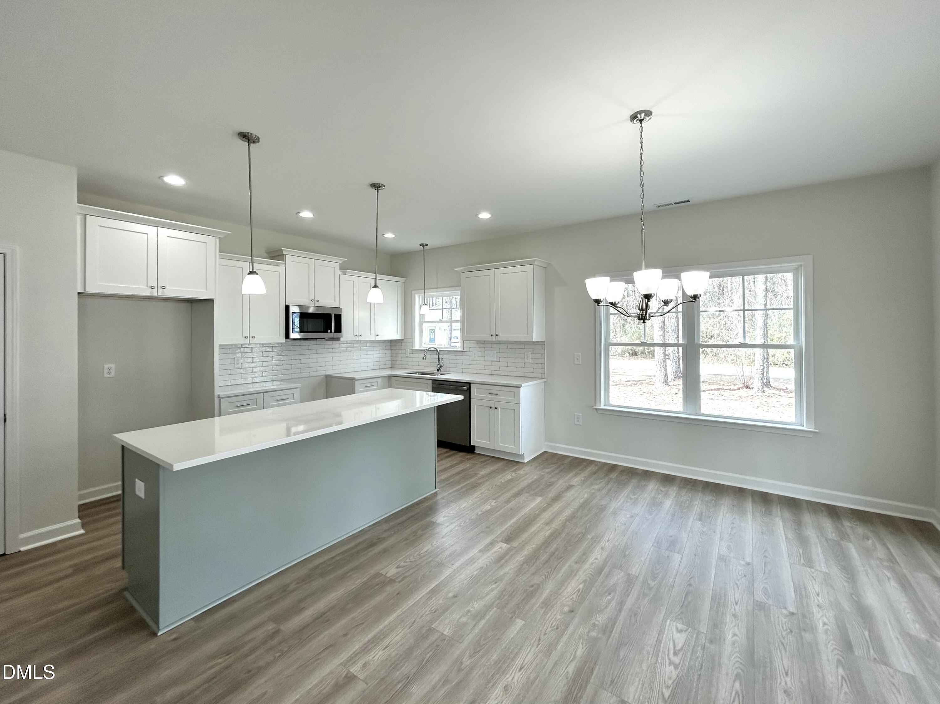 1739 Cardinal Drive Deep Run, NC 28525 - Photo 17 of 29 a large kitchen with stainless steel appliances a large counter top a sink a refrigerator and a window