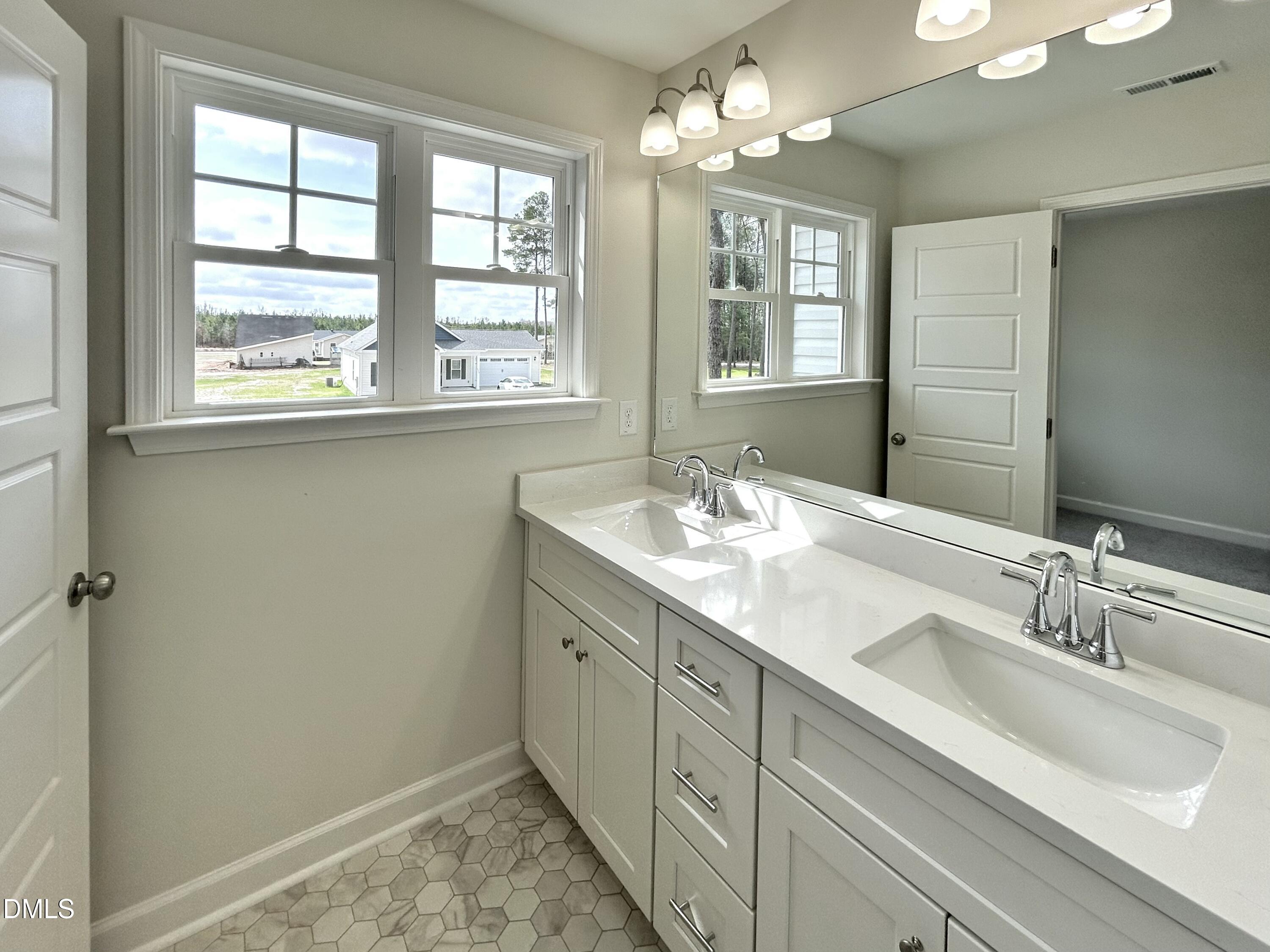 1739 Cardinal Drive Deep Run, NC 28525 - Photo 20 of 29 a bathroom with double sink and a window