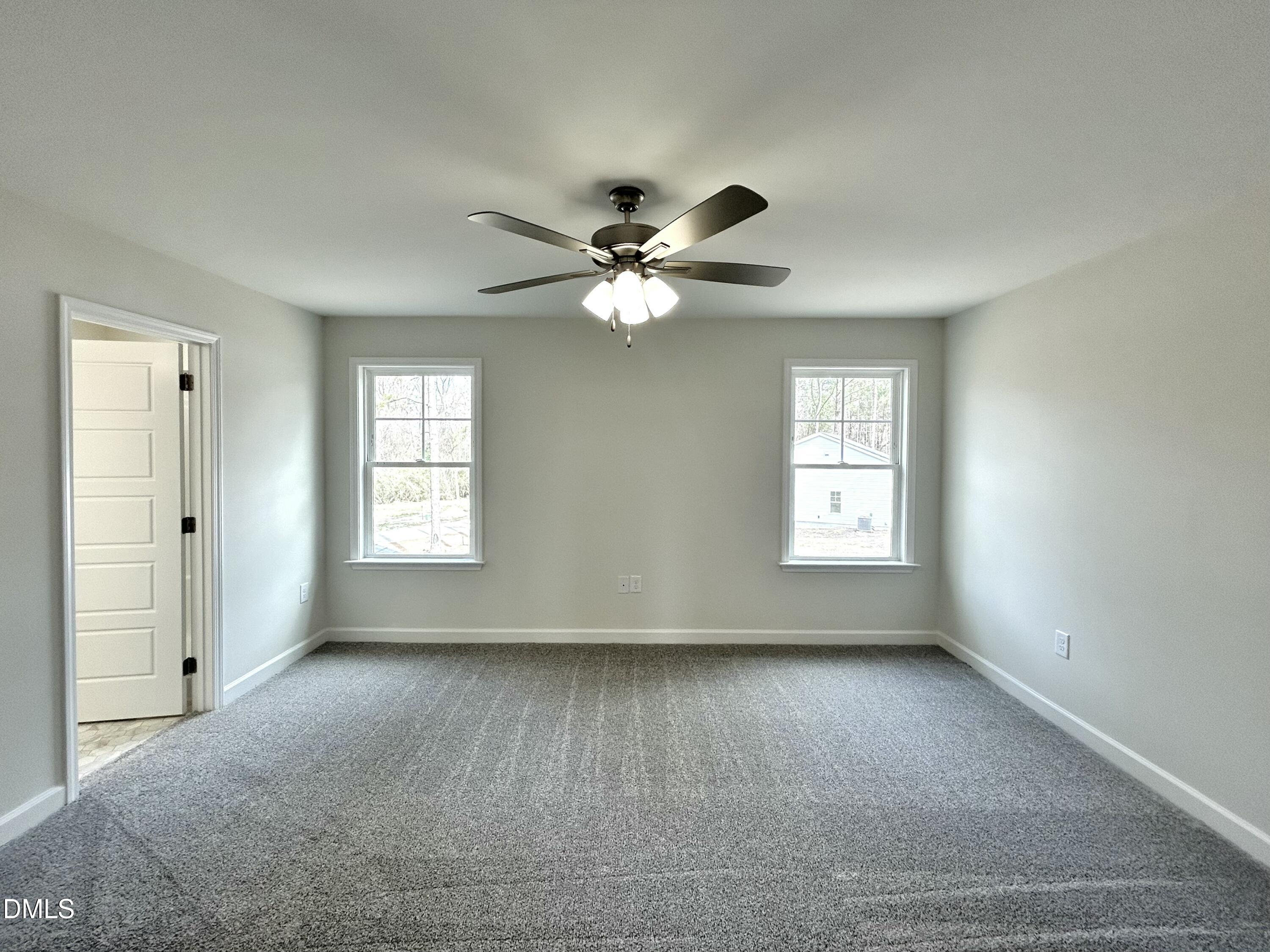 1739 Cardinal Drive Deep Run, NC 28525 - Photo 25 of 29 an empty room with windows and ceiling fan