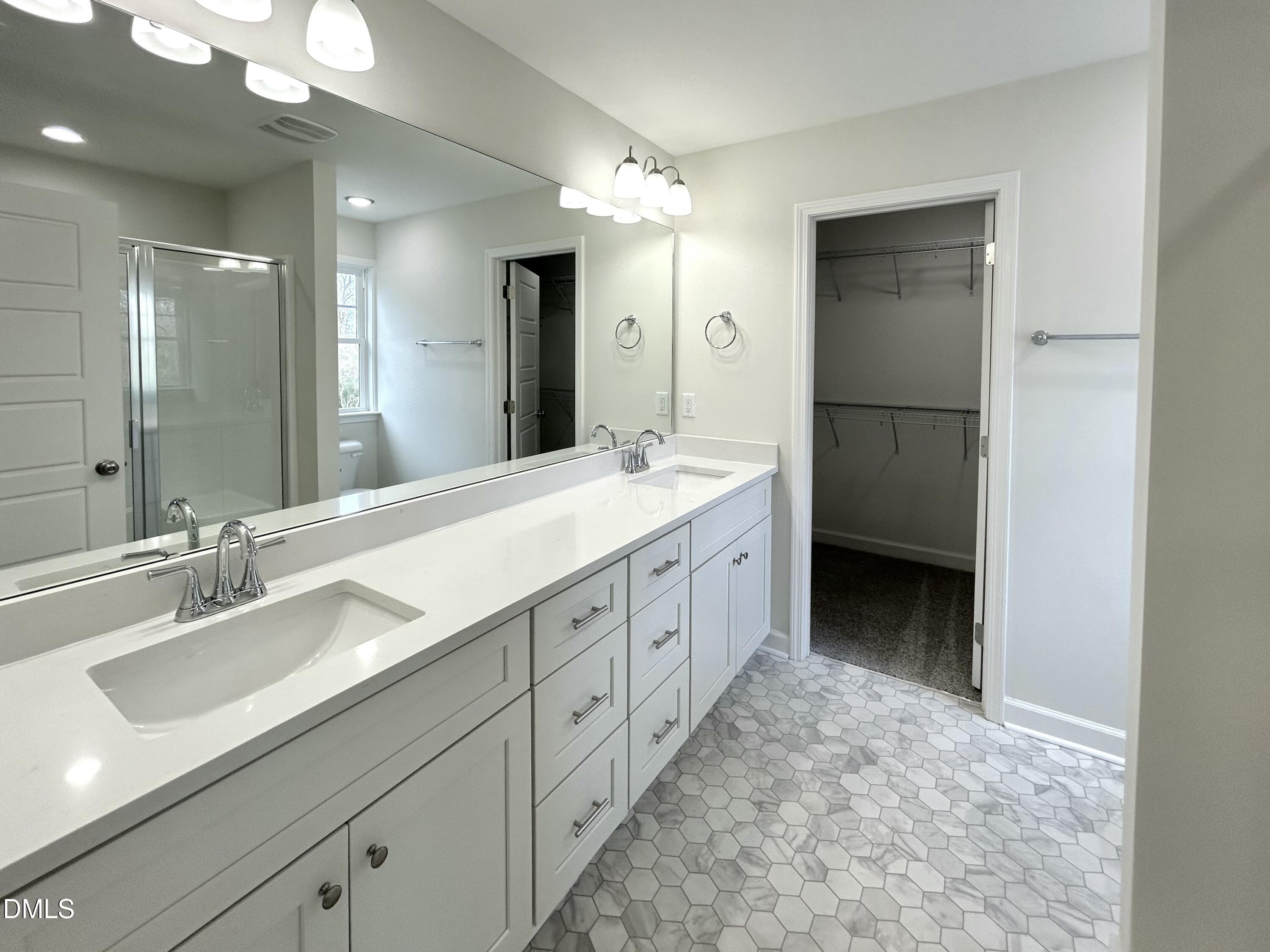 1739 Cardinal Drive Deep Run, NC 28525 - Photo 26 of 29 a spacious bathroom with a double vanity sink mirror and double