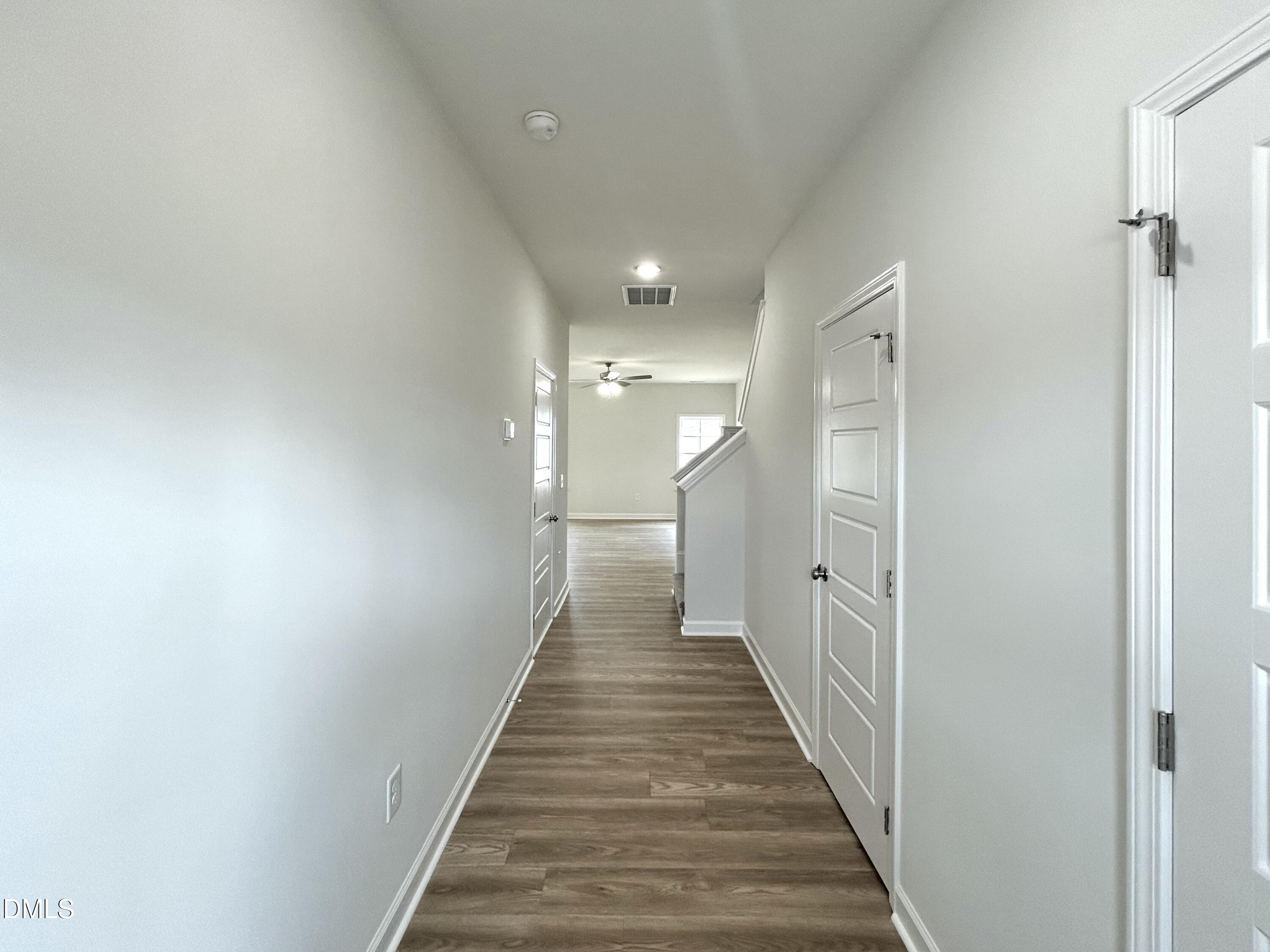 1739 Cardinal Drive Deep Run, NC 28525 - Photo 10 of 29 a view of a hallway with wooden floor and staircase