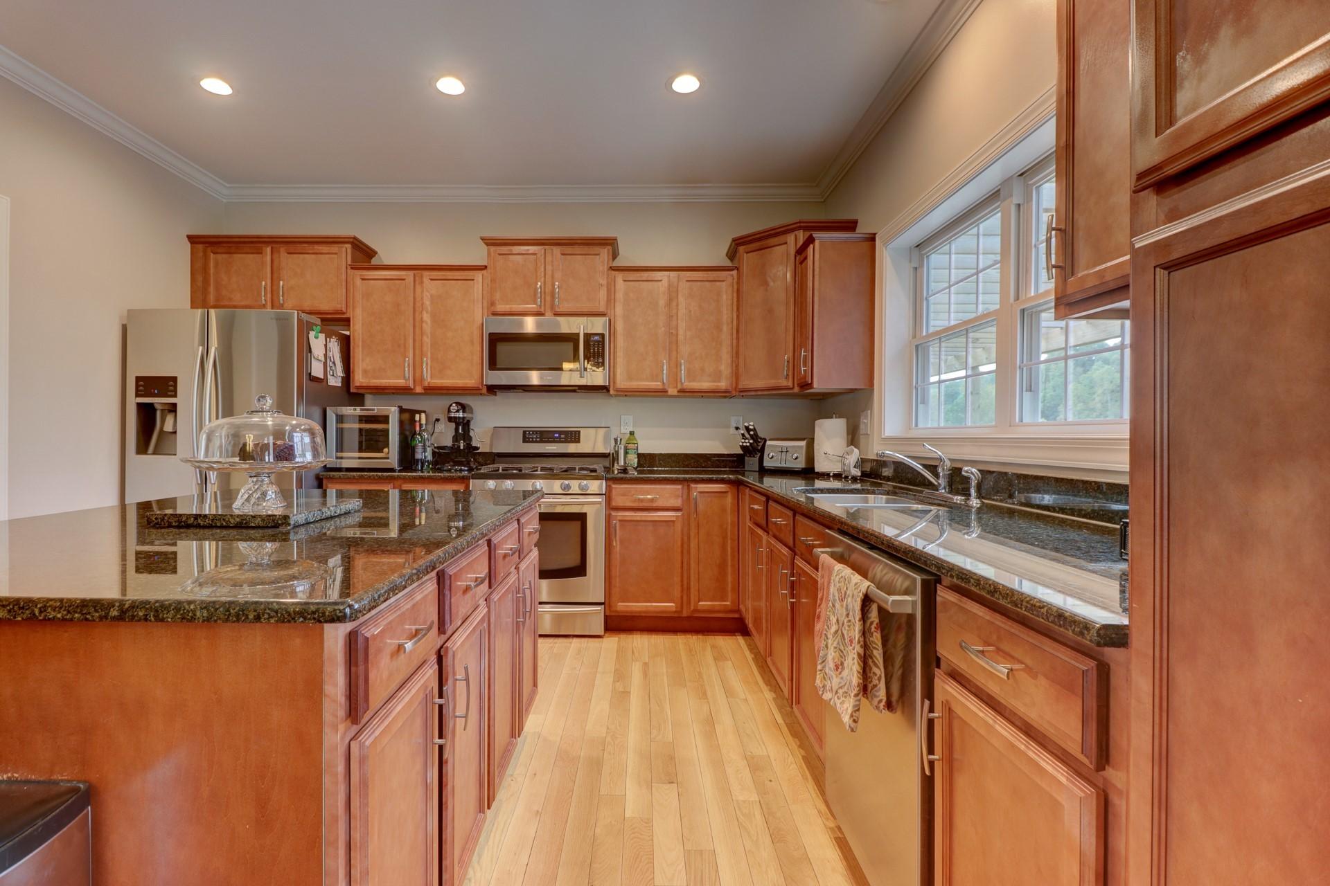 1491 Epperly Mill Road Southwest Floyd, VA 24091 - Photo 11 of 48 a kitchen with stainless steel appliances granite countertop a stove a sink and a refrigerator
