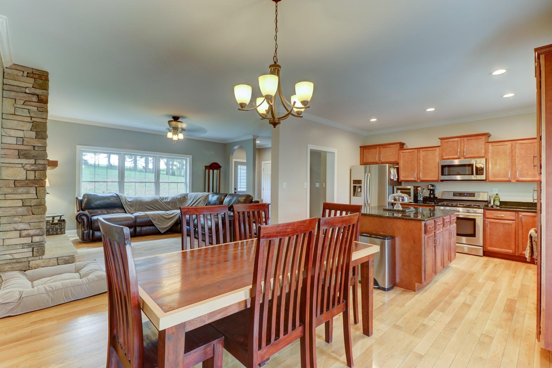 1491 Epperly Mill Road Southwest Floyd, VA 24091 - Photo 12 of 48 a view of a dining room and livingroom with furniture wooden floor a chandelier
