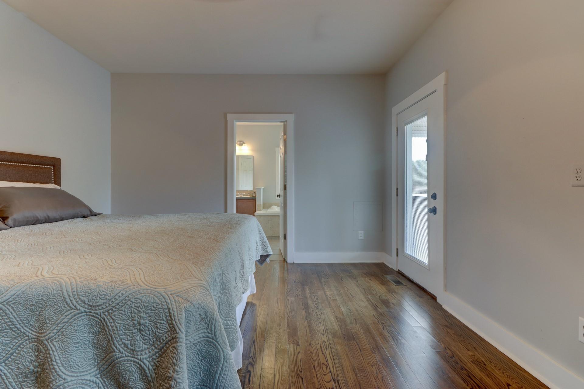 1491 Epperly Mill Road Southwest Floyd, VA 24091 - Photo 17 of 48 a spacious bedroom with a bed and wooden floor