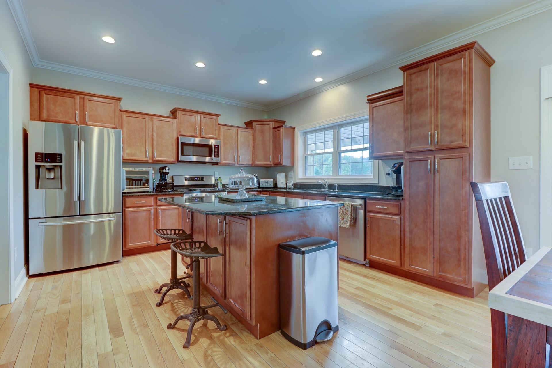 1491 Epperly Mill Road Southwest Floyd, VA 24091 - Photo 6 of 48 a kitchen with kitchen island granite countertop wooden floors appliances and cabinets