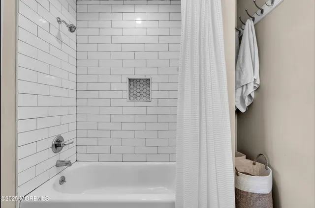 a bathroom with a bathtub and shower