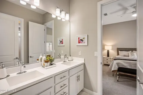 a en suite bathroom with double sink and a mirror