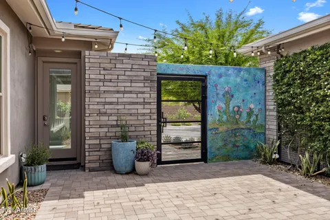 a view of a door and chair and tables in the patio